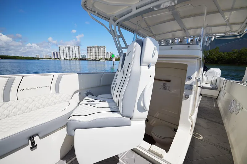  Yacht Photos Pics 2007 Midnight Express Cuddy boat interior with seating and cabin, docked near waterfront buildings.