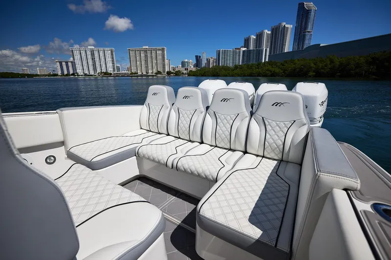  Yacht Photos Pics Luxurious 2007 Midnight Express Cuddy boat interior with white seating, city skyline in background.