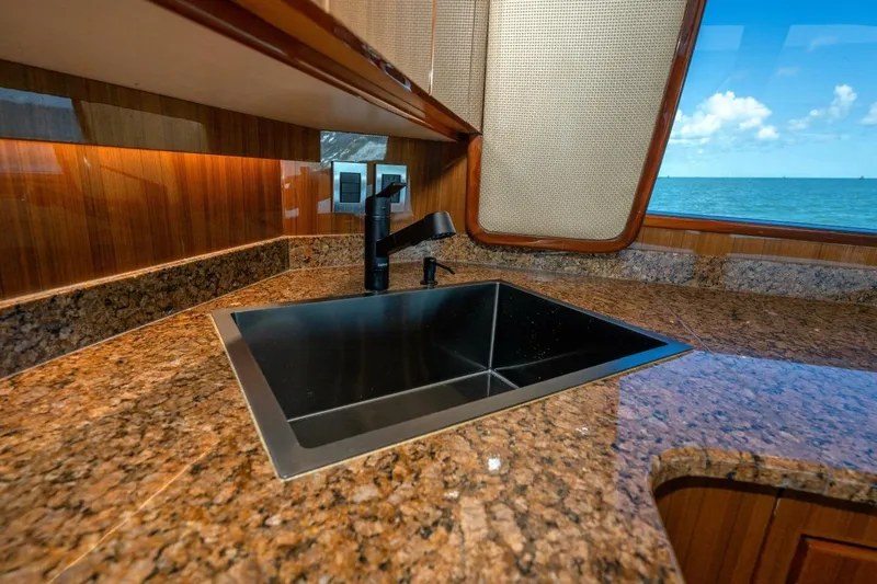Stay Salty Yacht Photos Pics Luxurious kitchen sink in 2009 Viking 50 Convertible yacht with ocean view.