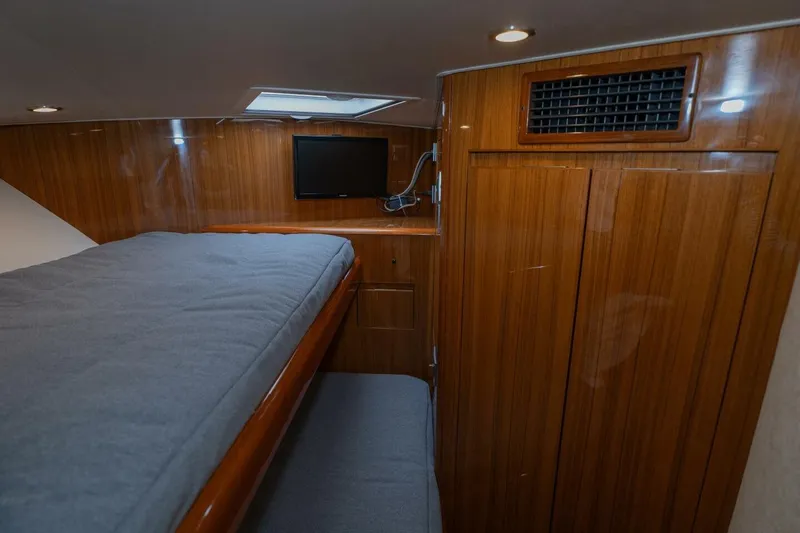 Stay Salty Yacht Photos Pics 2009 Viking 50 Convertible yacht cabin with wooden interior and bunk beds.