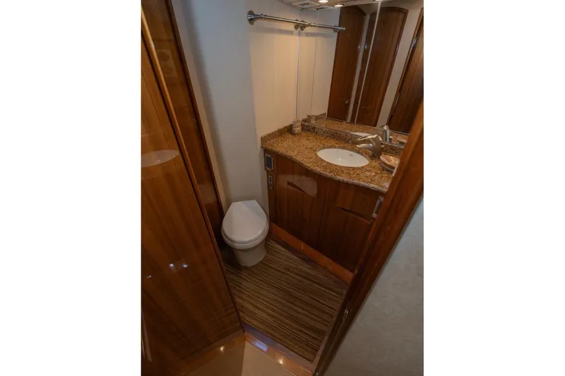 Stay Salty Yacht Photos Pics Luxurious bathroom in 2009 Viking 50 Convertible yacht with granite countertop and wooden cabinetry.