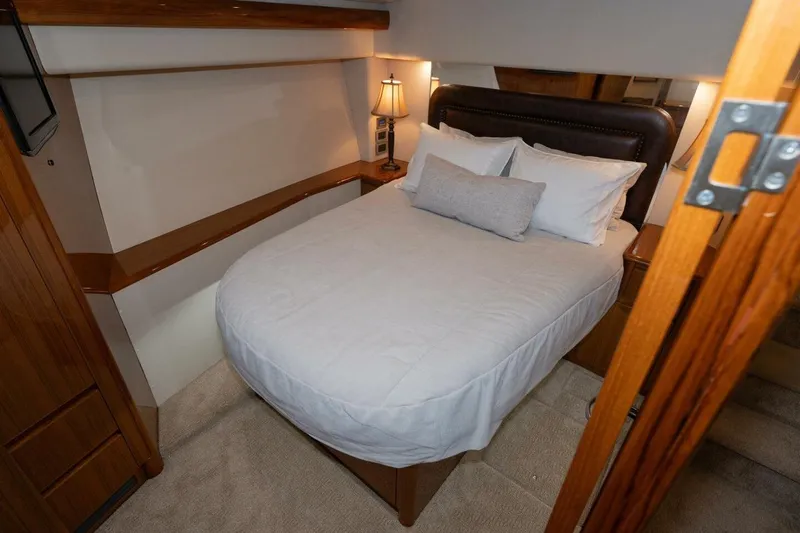 Stay Salty Yacht Photos Pics Luxurious bedroom interior of 2009 Viking 50 Convertible yacht with cozy bedding.