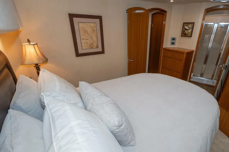 Stay Salty Yacht Photos Pics Luxurious bedroom interior on 2009 Viking 50 Convertible yacht, featuring elegant decor and cozy bedding.