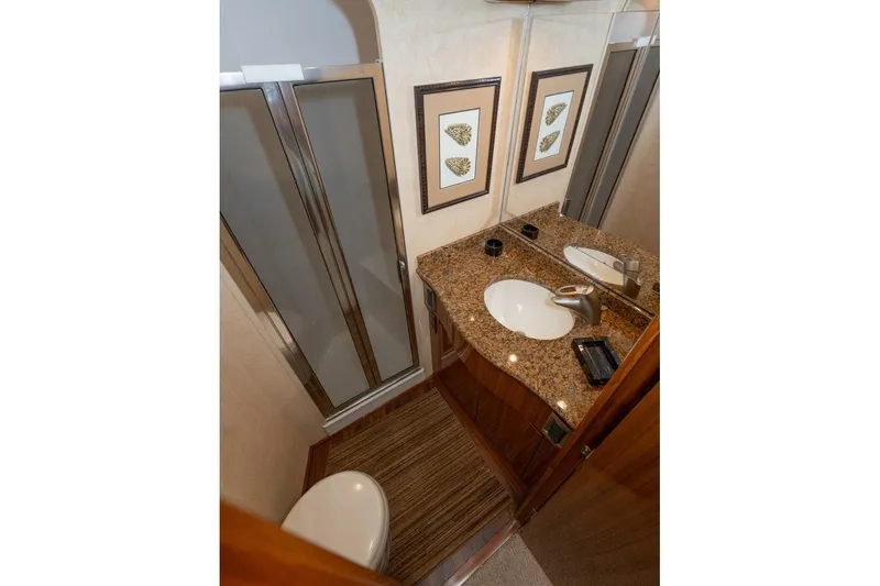 Stay Salty Yacht Photos Pics Luxurious bathroom in 2009 Viking 50 Convertible yacht with granite countertop and shower.