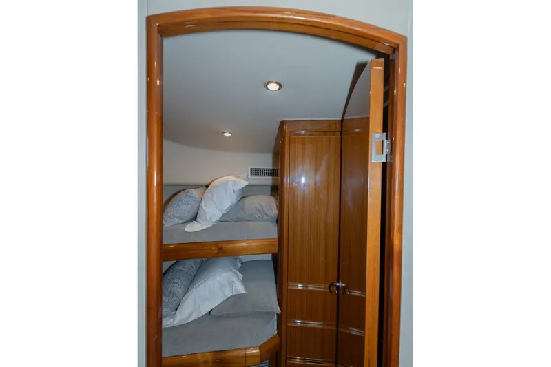 Stay Salty Yacht Photos Pics Interior of 2009 Viking 50 Convertible yacht with wooden bunk beds and closet.
