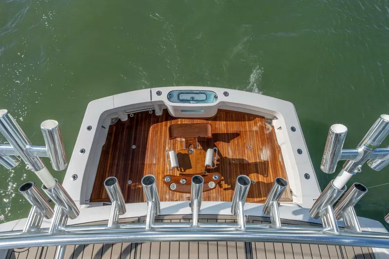 Stay Salty Yacht Photos Pics 2009 Viking 50 Convertible yacht deck with fishing rod holders and teak flooring.