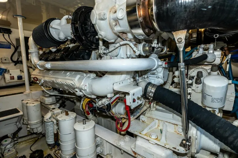 Stay Salty Yacht Photos Pics Engine room of 2009 Viking 50 Convertible yacht, showcasing detailed machinery components.