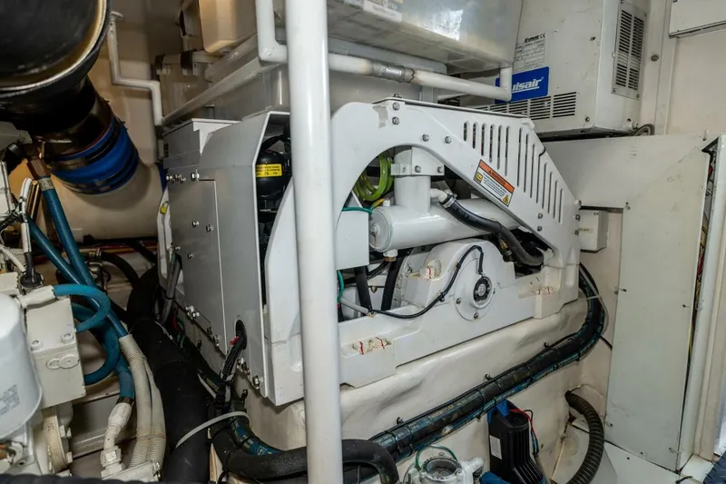 Stay Salty Yacht Photos Pics Engine room of 2009 Viking 50 Convertible yacht, showcasing mechanical components and wiring.