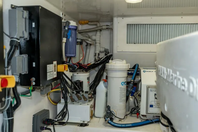 Stay Salty Yacht Photos Pics Engine room of a 2009 Viking 50 Convertible yacht with various equipment and wiring.