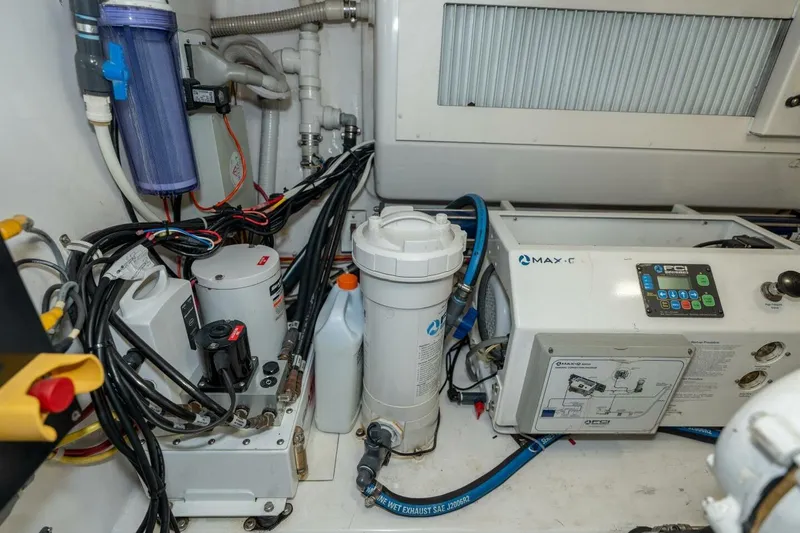 Stay Salty Yacht Photos Pics Engine room of 2009 Viking 50 Convertible yacht with various mechanical components.