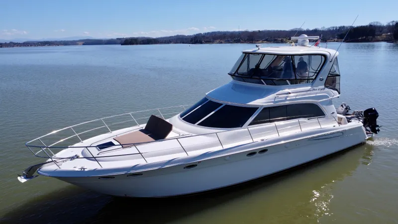  Yacht Photos Pics 2001 Sea Ray 480 Sedan Bridge yacht on calm water, showcasing sleek design and spacious deck.