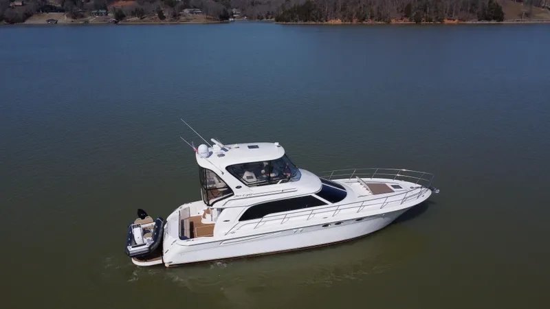  Yacht Photos Pics 2001 Sea Ray 480 Sedan Bridge yacht on calm lake waters.