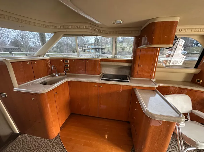  Yacht Photos Pics Luxurious kitchen interior of 2001 Sea Ray 480 Sedan Bridge yacht with wooden cabinetry.