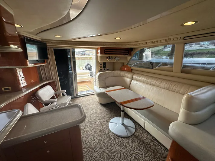  Yacht Photos Pics Luxurious interior of 2001 Sea Ray 480 Sedan Bridge yacht with elegant seating and modern amenities.