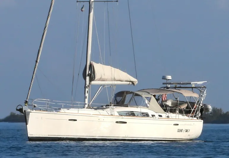 Island Time Ll Yacht Photos Pics 2008 Beneteau 46 sailboat on calm blue water, side view.