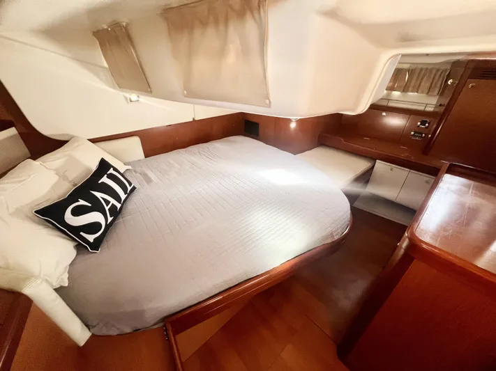 Island Time Ll Yacht Photos Pics Interior cabin of 2008 Beneteau 46 yacht with bed and wooden furnishings.