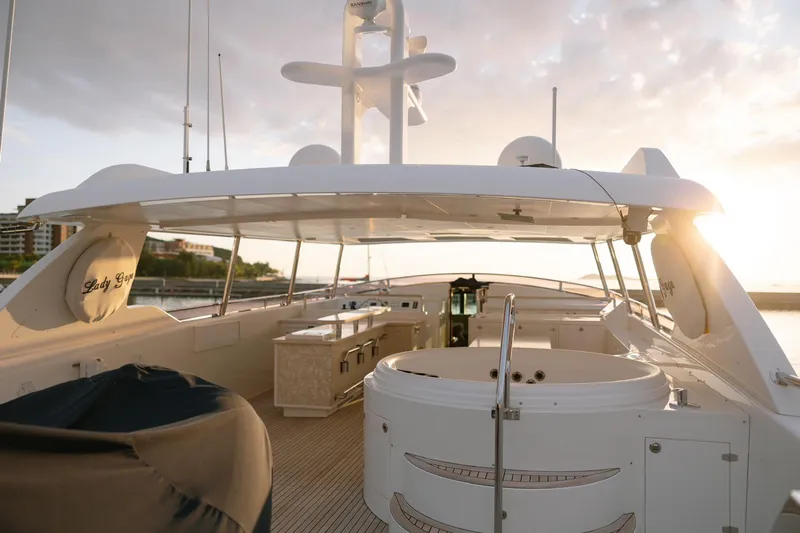  Yacht Photos Pics Luxurious Horizon 110 yacht deck at sunset, featuring a jacuzzi and elegant seating, 2011 model.