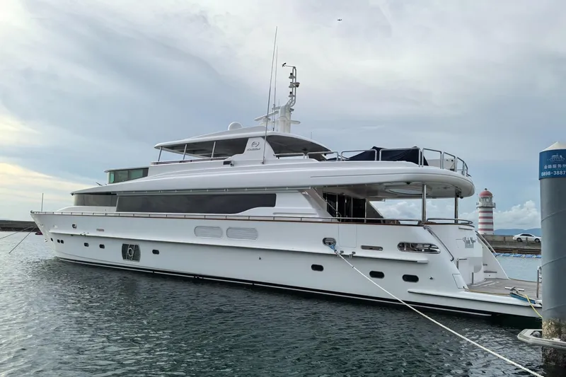  Yacht Photos Pics Luxurious 2011 Horizon 110 yacht docked at marina with lighthouse in background.