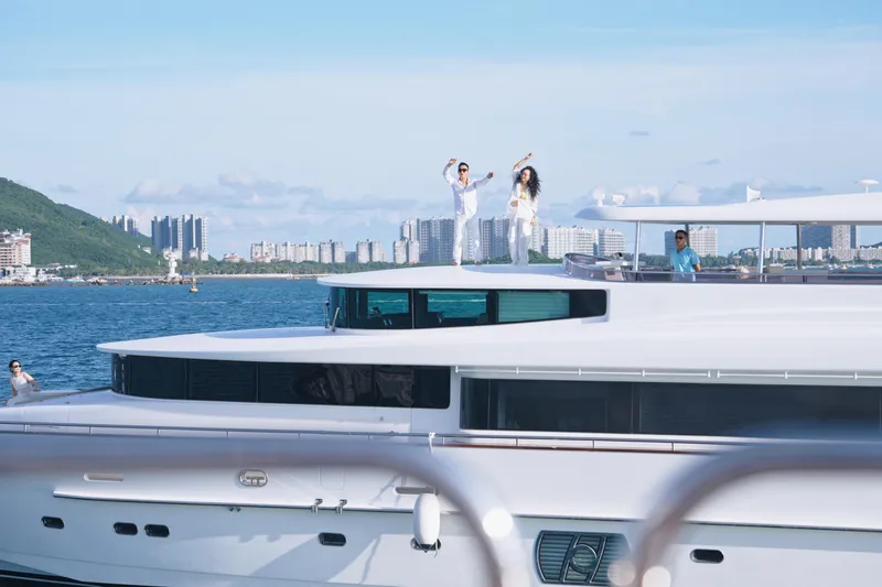  Yacht Photos Pics Luxury Horizon 110 yacht cruising with people enjoying on deck, city skyline in background, 2011 model.