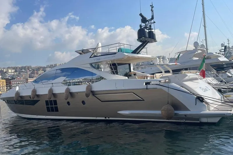  Yacht Photos Pics Luxury 2018 Azimut 77S yacht docked in a marina under a clear sky.