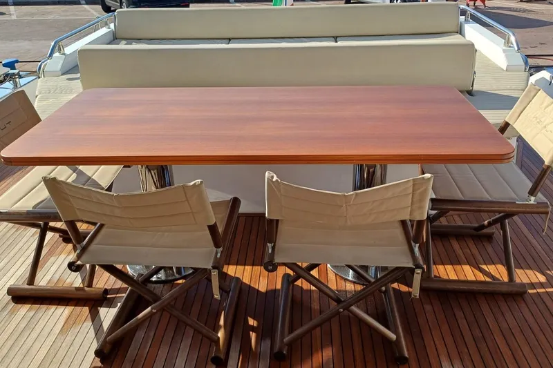  Yacht Photos Pics Luxury Azimut 77S yacht deck with wooden table and folding chairs, 2018 model.