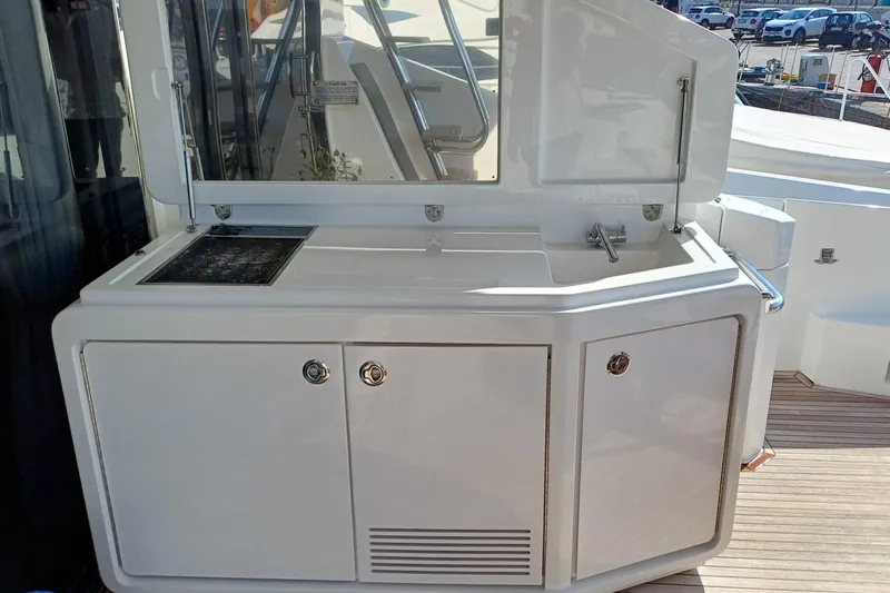  Yacht Photos Pics Outdoor kitchen area on 2018 Azimut 77S yacht, featuring sink and storage cabinets.