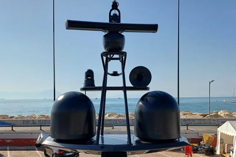  Yacht Photos Pics Radar and communication equipment on a 2018 Azimut 77S yacht, with a coastal backdrop.