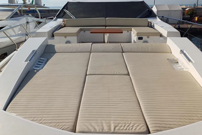  Yacht Photos Pics Luxurious sunbathing area on 2018 Azimut 77S yacht, featuring comfortable beige cushions.