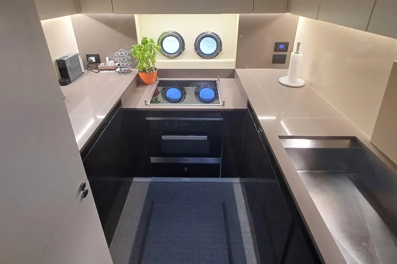  Yacht Photos Pics Modern kitchen interior on 2018 Azimut 77S yacht with sleek countertops and appliances.