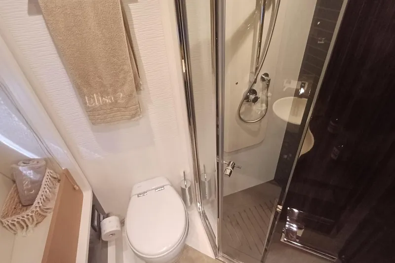  Yacht Photos Pics Luxurious bathroom in 2018 Azimut 77S yacht with shower, toilet, and elegant decor.