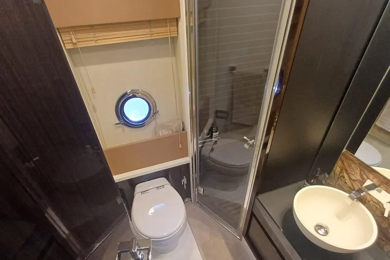  Yacht Photos Pics Bathroom interior of 2018 Azimut 77S yacht with porthole, shower, and sink.