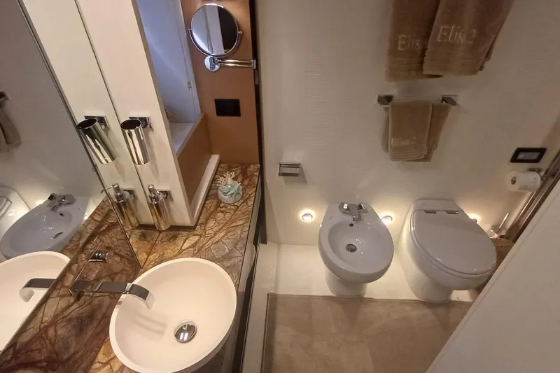  Yacht Photos Pics Luxurious bathroom in 2018 Azimut 77S yacht with elegant fixtures and marble countertop.