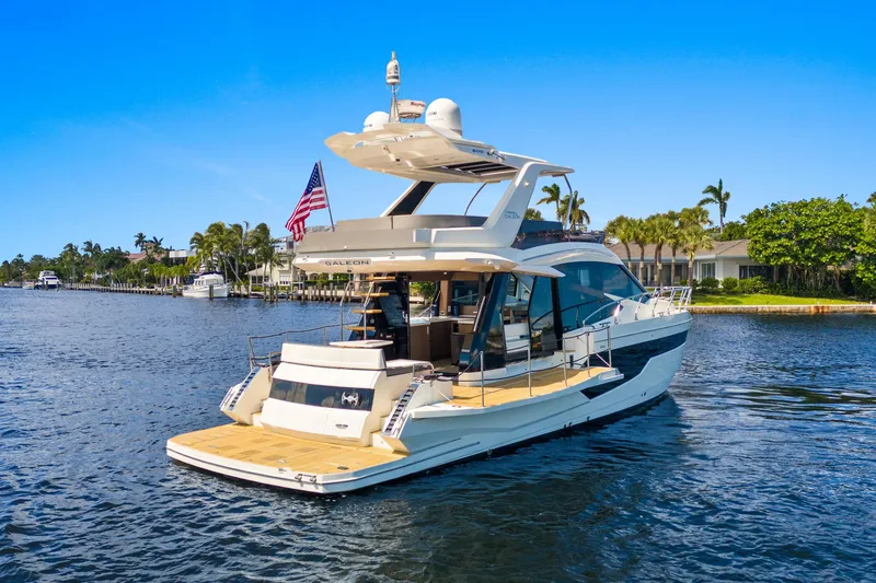  Yacht Photos Pics 2021 Galeon 500 Fly yacht cruising on a sunny day, featuring sleek design and spacious deck.