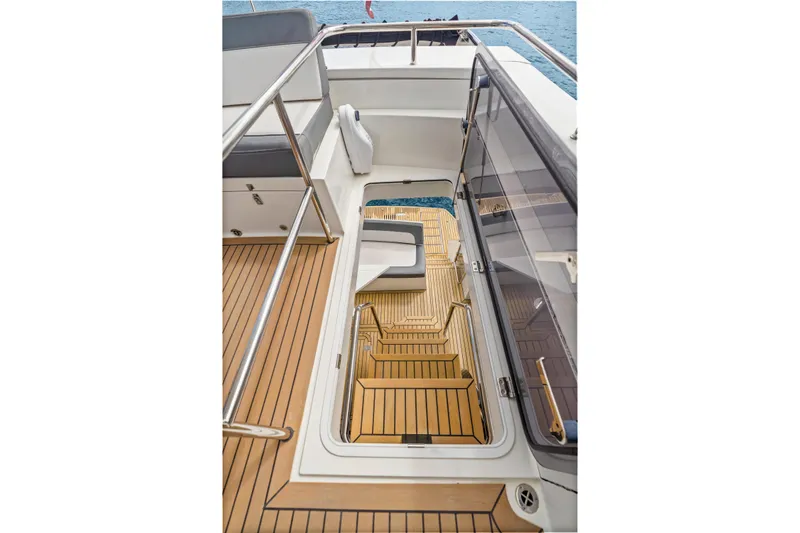  Yacht Photos Pics Staircase on 2021 Galeon 500 Fly yacht with teak flooring and stainless steel railings.