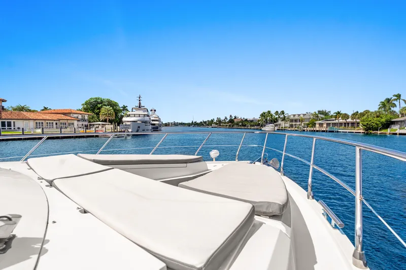  Yacht Photos Pics 2021 Galeon 500 Fly yacht cruising in a scenic waterfront neighborhood.