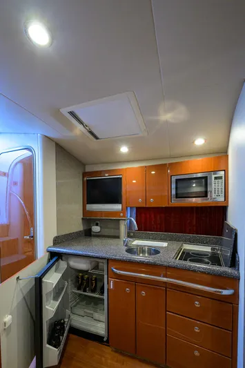 Sababa Yacht Photos Pics 2007 Formula 37 PC yacht kitchen with modern appliances and wood cabinetry.