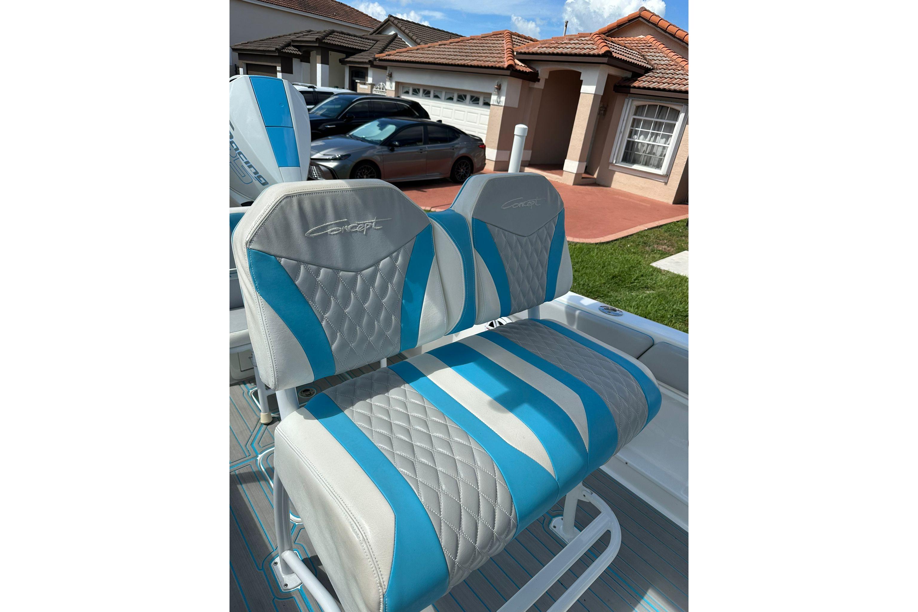 Luxurious seating on 2019 Concept 27' CC boat, featuring blue and white upholstery.