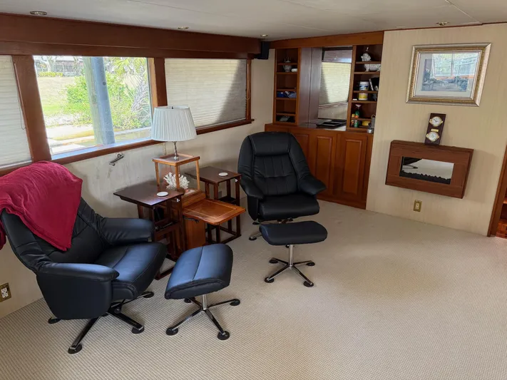 Miss Wendy Yacht Photos Pics Interior of 1972 Burger 81 Raised Pilothouse with chairs, lamp, and built-in shelves.