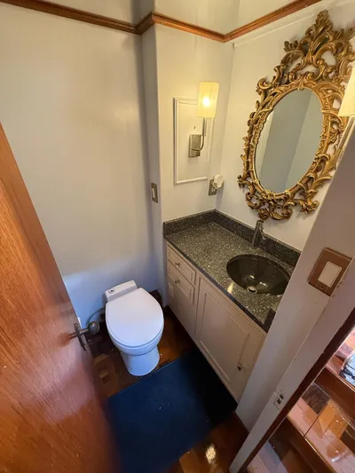 Miss Wendy Yacht Photos Pics Luxurious bathroom on 1972 Burger 81 Raised Pilothouse yacht with ornate mirror and modern fixtures.