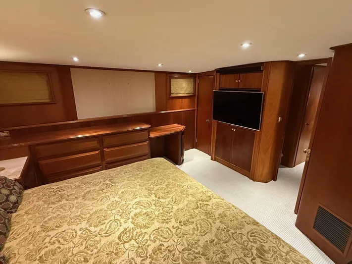 Miss Wendy Yacht Photos Pics Luxurious interior of 1972 Burger 81 Raised Pilothouse yacht with wood paneling and elegant bedding.