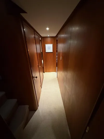 Miss Wendy Yacht Photos Pics Narrow hallway inside 1972 Burger 81 Raised Pilothouse yacht with wooden paneling.