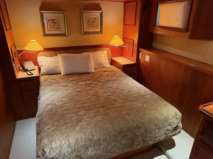 Miss Wendy Yacht Photos Pics Cozy bedroom interior on 1972 Burger 81 Raised Pilothouse yacht with warm lighting.