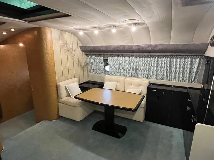  Yacht Photos Pics Interior of a 1989 Riva 60 Black Corsair yacht with elegant seating and dining area.