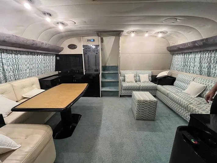  Yacht Photos Pics Luxurious interior of a 1989 Riva 60 Black Corsair yacht with elegant seating and table.