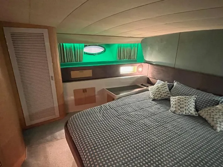  Yacht Photos Pics Luxurious cabin interior of 1989 Riva 60 Black Corsair yacht with cozy bedding.