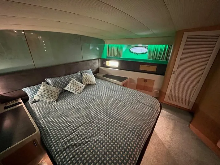  Yacht Photos Pics Luxurious cabin interior of 1989 Riva 60 Black Corsair yacht with cozy bedding.