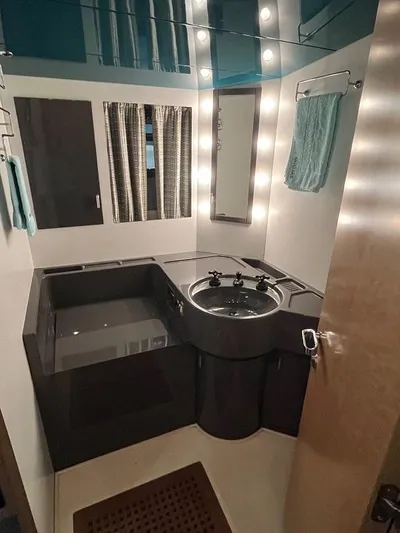  Yacht Photos Pics Luxurious bathroom interior of 1989 Riva 60 Black Corsair yacht with modern fixtures.