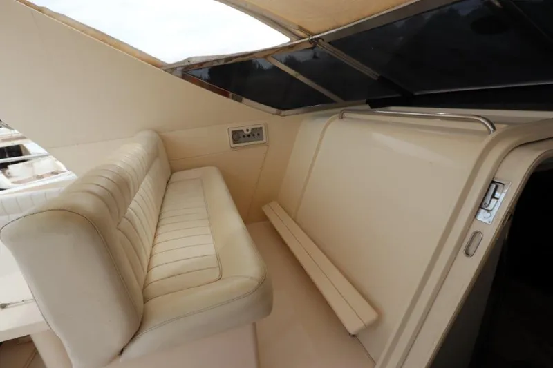  Yacht Photos Pics 1989 Riva 60 Black Corsair yacht interior with beige seating and sleek design.