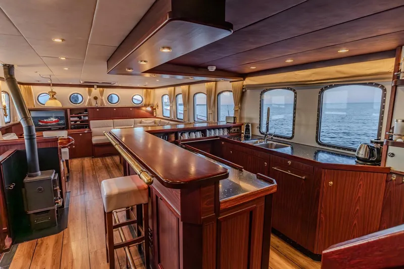 San Gottardo Yacht Photos Pics Luxurious interior of 2009 Altena Expedition yacht with wooden furnishings and ocean view.