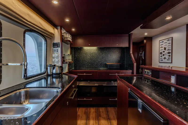 San Gottardo Yacht Photos Pics Luxurious 2009 Altena Expedition yacht kitchen with modern appliances and elegant wood finishes.